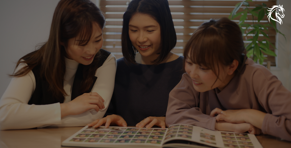 Three young women look at a school yearbook