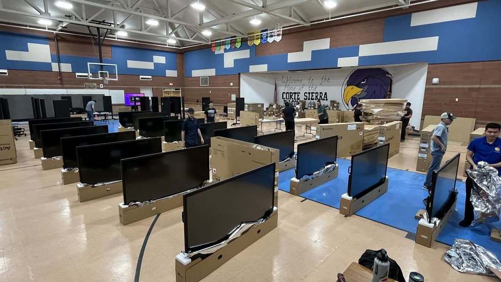Monitor screens set up on gym floor