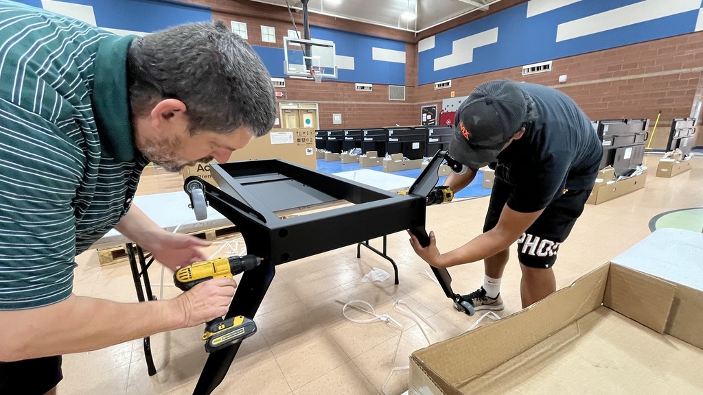 IT members assembling monitor screens