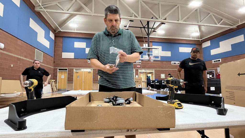 IT members assembling monitor screens