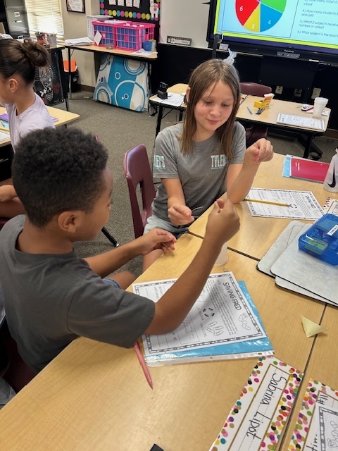 Fifth Grade Students working to Save Fred the gummy worm.