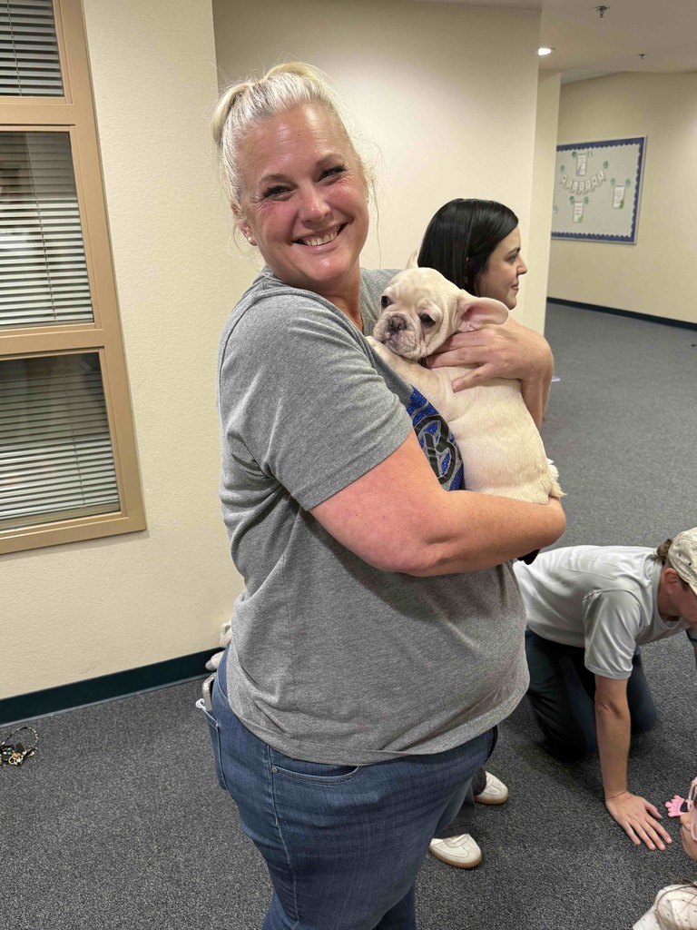Teachers holding bulldog puppies