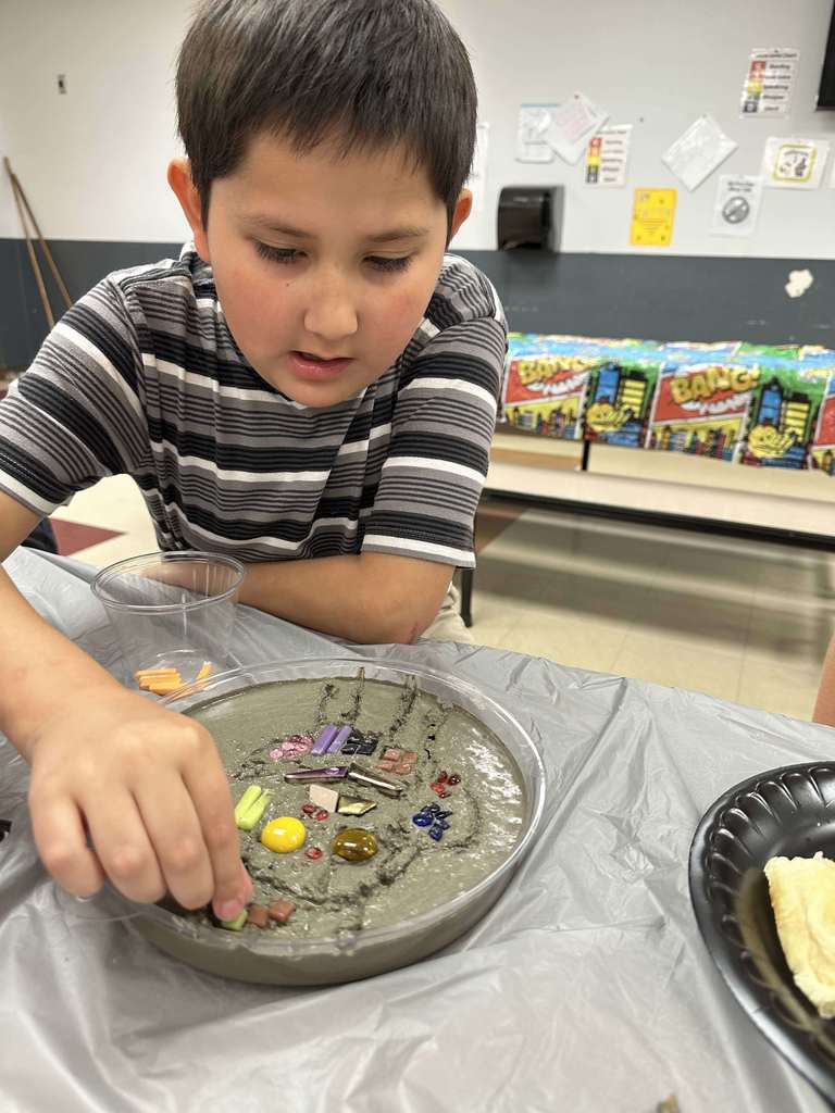 Student creating mosaic tiles