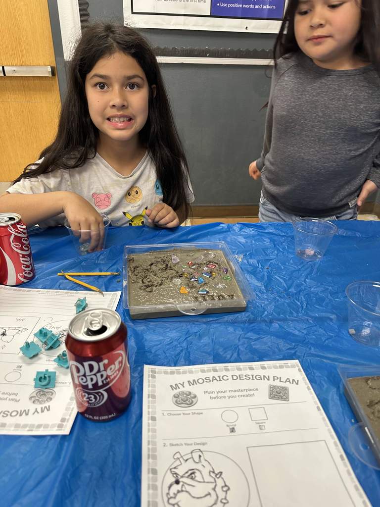 Student creating mosaic tiles