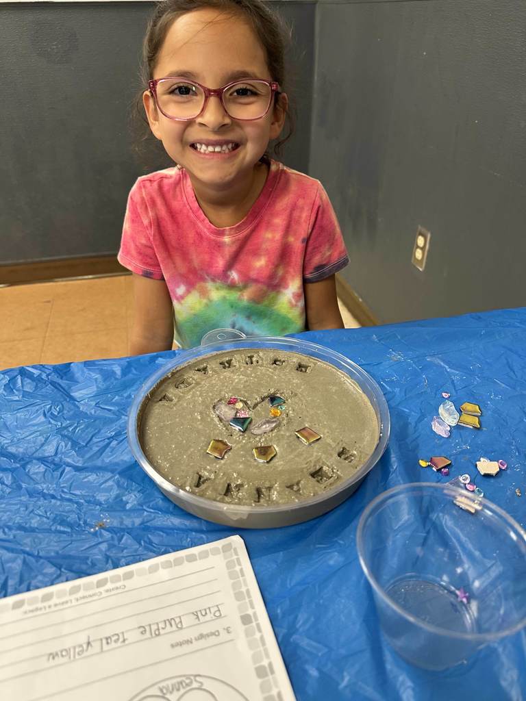 Student creating mosaic tiles