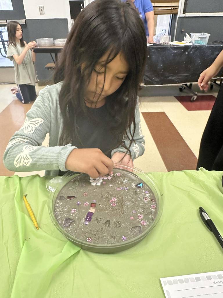 Student creating mosaic tiles