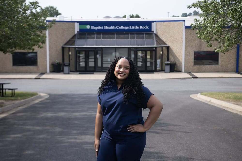 Karis Wesson, a graduate of the Little Rock School District's practical nursing program, poses for a portrait at Baptist Health College Little Rock on Friday, Aug. 21, 2026. The college collaborates with the district on the program. (Arkansas Democrat-Gazette/Adam Vogler)
