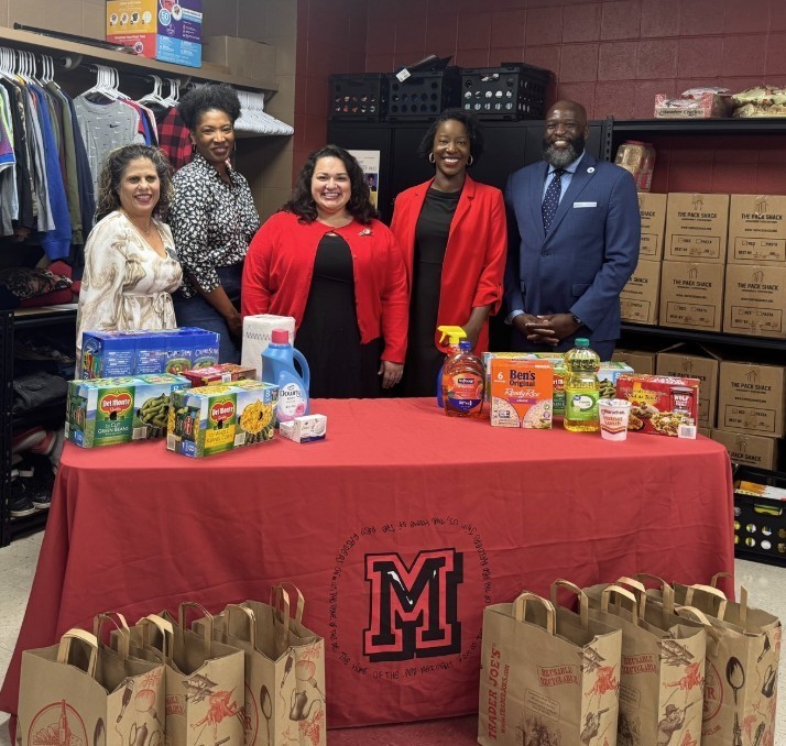 photo of Mabelvale staff, principal, Supt. Dr. Wright, Rep. Denise Ennett, and a few groceries on table with bags on floor