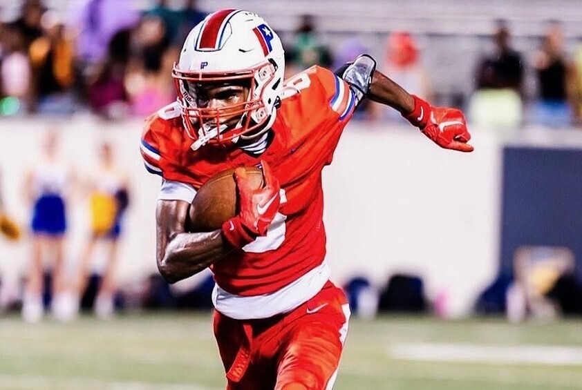 2027 DB/WR Carmelo Johnson running with a football. (Photo courtesy of Reece Wade of Shot By Reece)