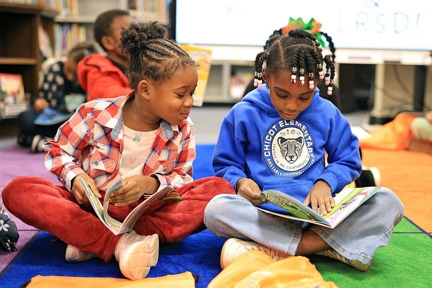 Alicia Fuller (left), 6, a first-grade student at Chicot Elementary School in Little Rock, looks over at first-grader Za'liyah Burl, 6, as they read their new books together as part of the Reading in the Rock literacy initiative sponsored by the city of Little Rock and the Little Rock School District in this Dec. 15, 2025, file photo. (Arkansas Democrat-Gazette/Colin Murphey)