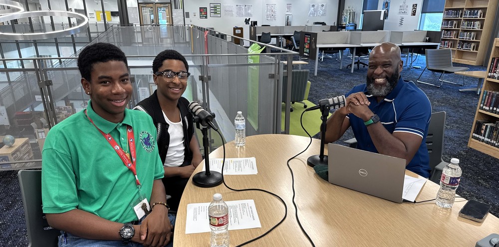 Supt. Dr. Jermall Wright poses with two LRSD students while filming a podcast