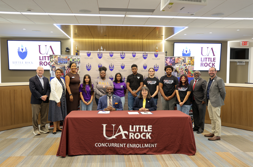 LRSD students and staff pose with staff from UALR during the announcement of a new partnership