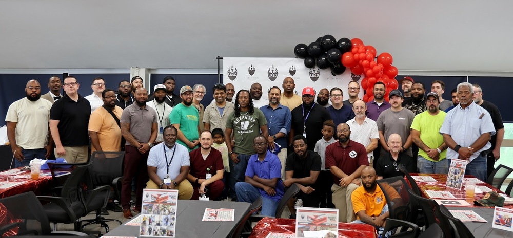 LRSD Dads/Father-Figures pose for a picture at LRSD's annual luncheon.