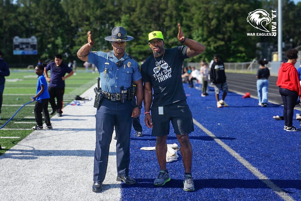 Coach Knight and Police Officer at JA Fair K8 Field Day 2026