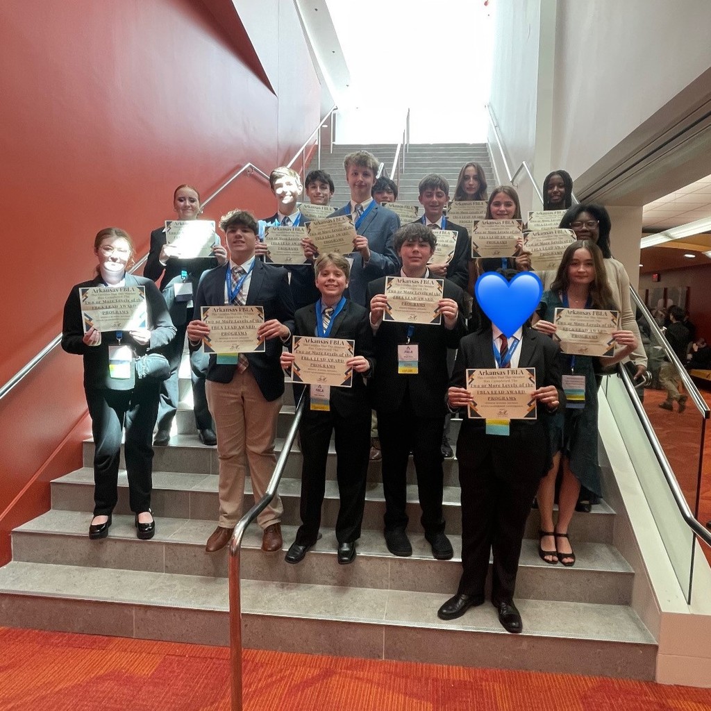 PHMS FBLA students posing with awards on a staircase at state.