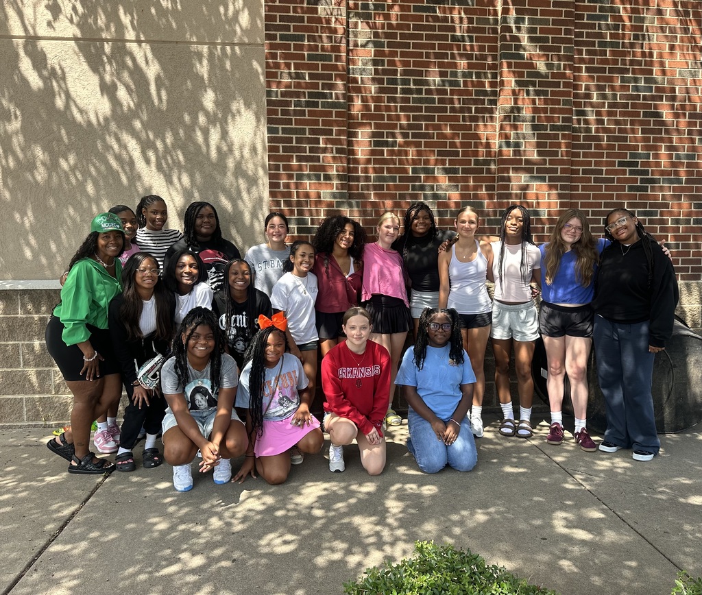 PHMS Volleyball team and coach posing outside