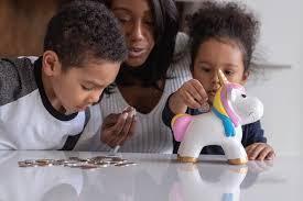 An image of kids counting change to put in a piggy bank.
