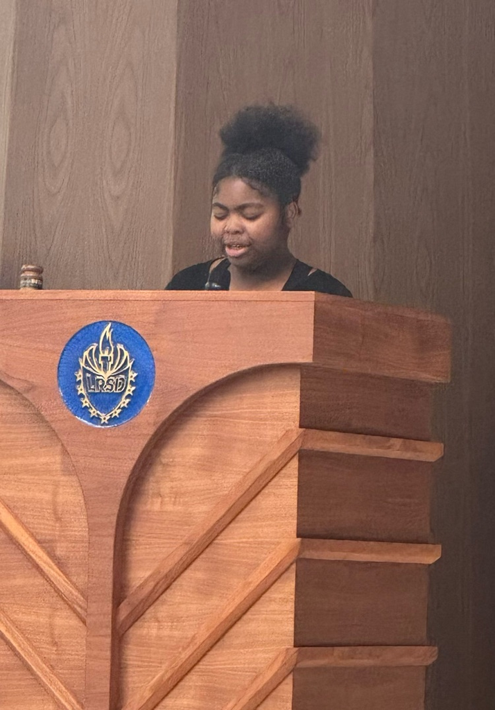 The secretary is standing at the podium, giving a speech