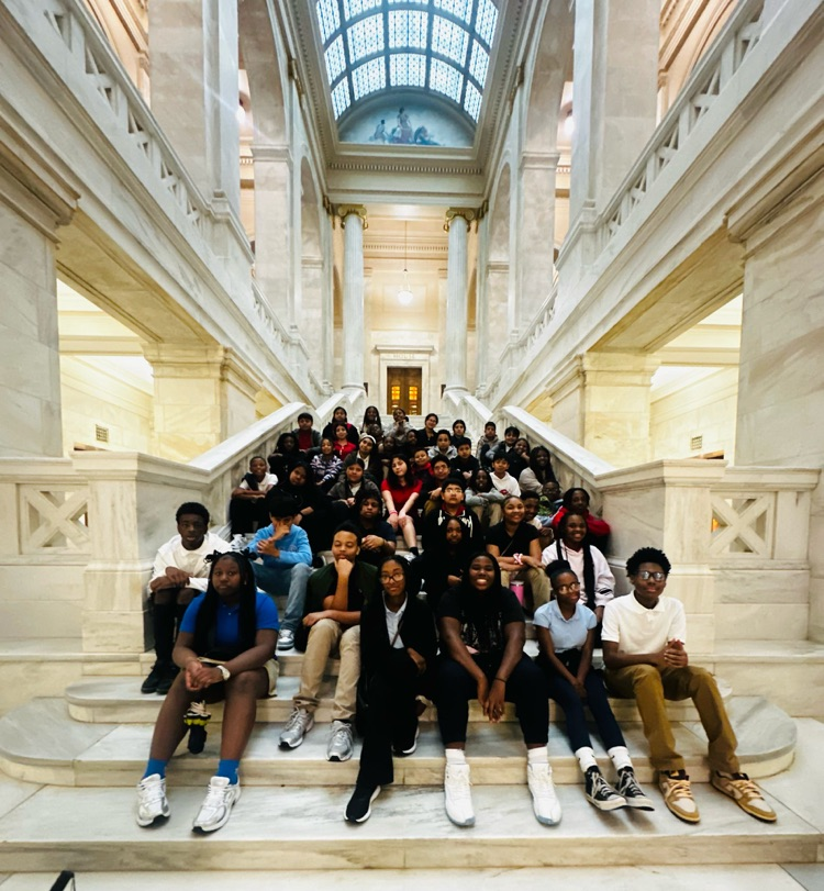 Students are taking a picture together in the state capitol 