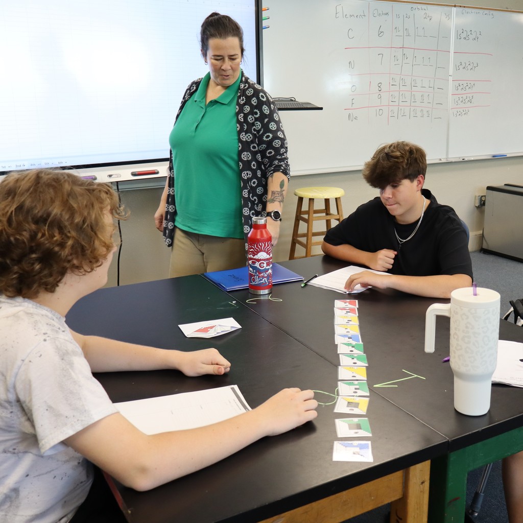 Students working together to organize cards