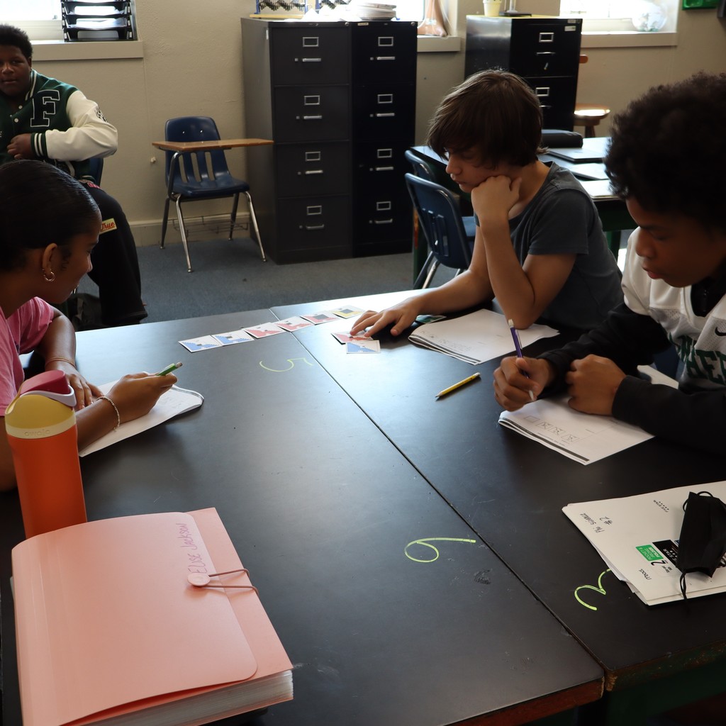 Students working together to organize cards