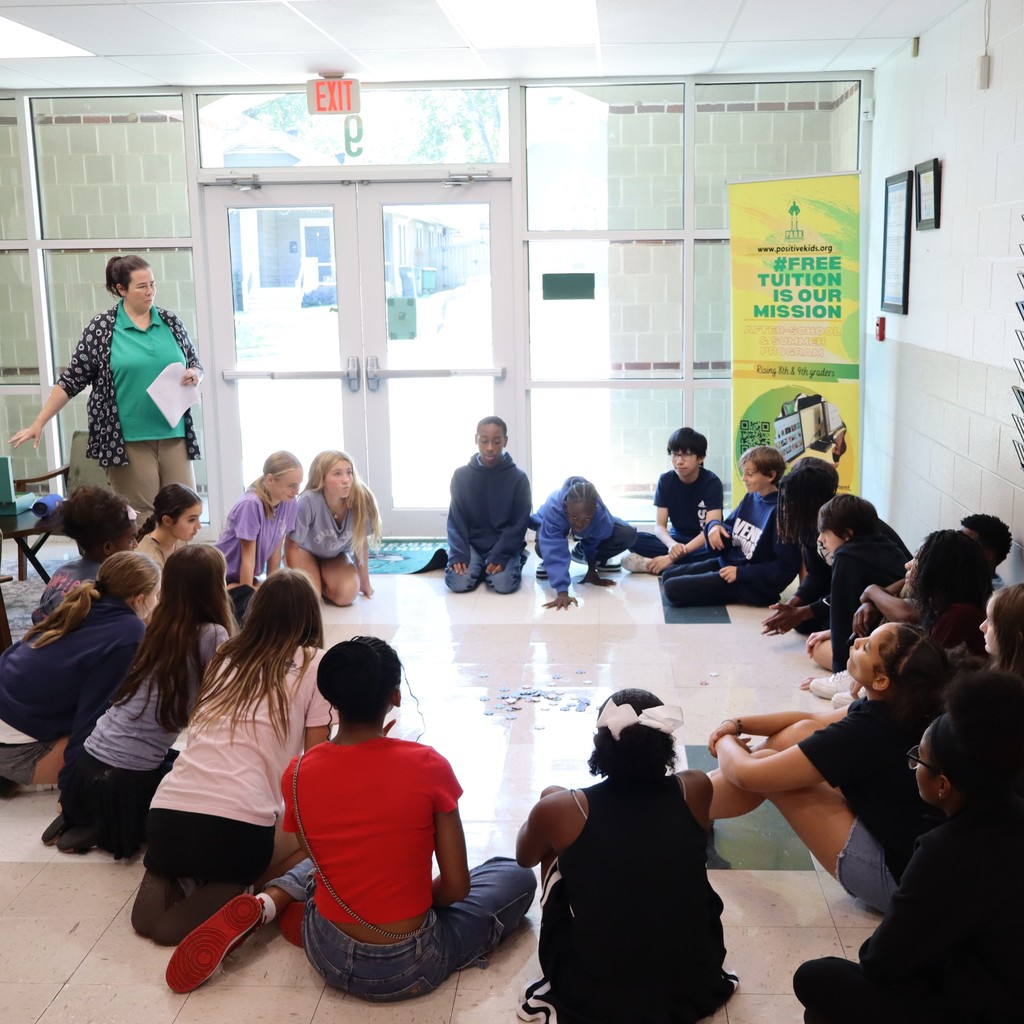 Students grouped together discussing resources