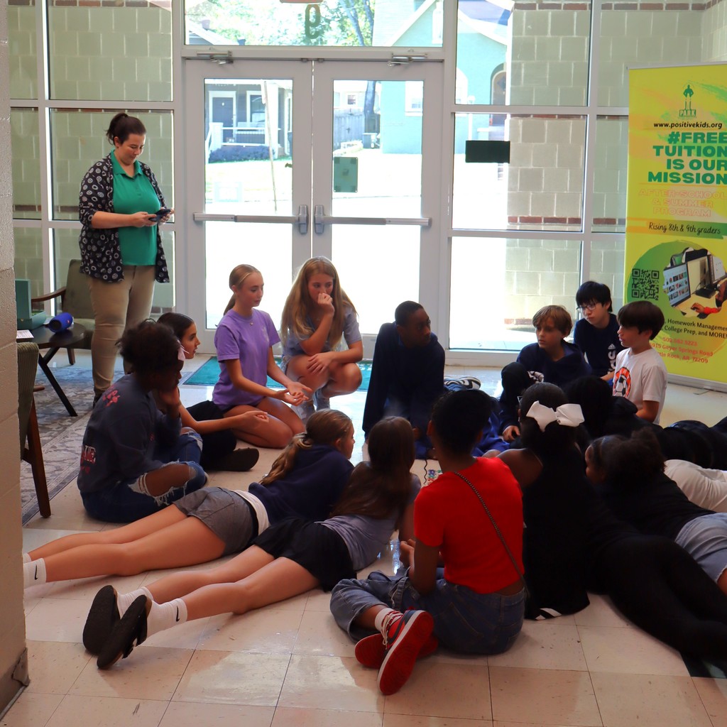 Students grouped together discussing resources