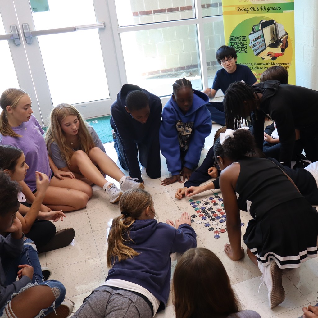 Students grouped together discussing resources