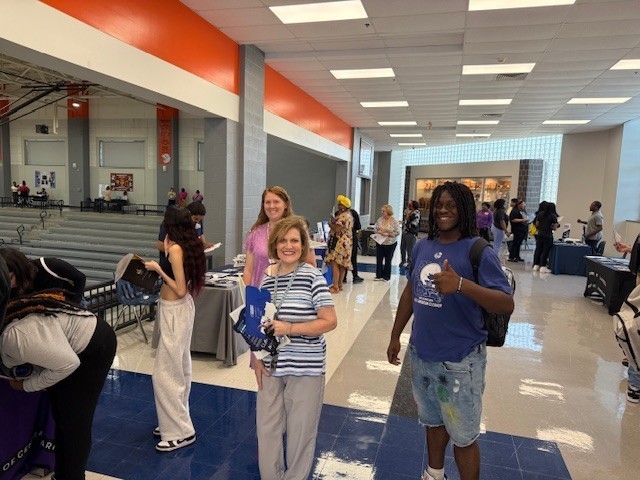 Two teachers and a student are shown at Career Fair 