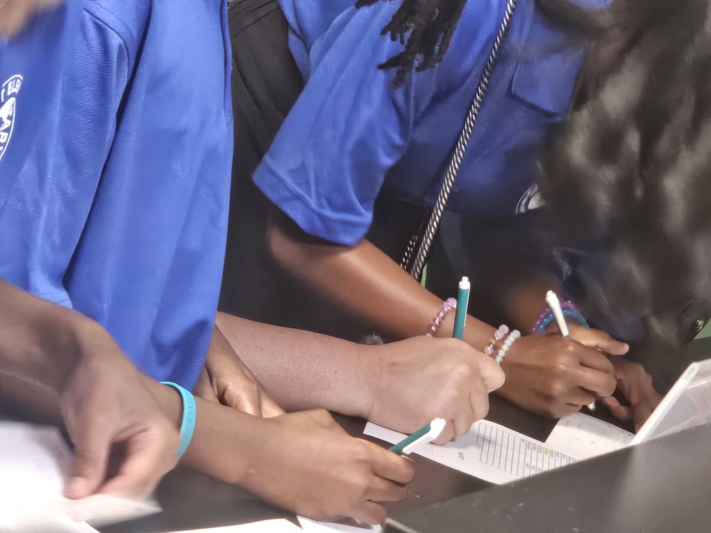 Image of student tellers working at the school bank.