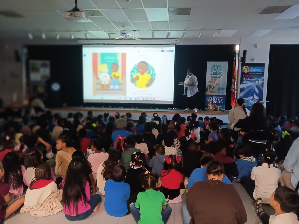 Image of author talking to an assembled group of students. 