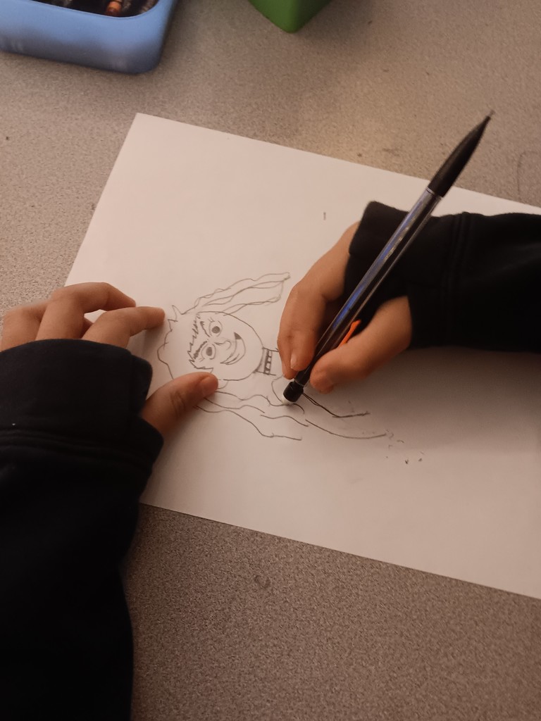 Image of a close-up of student's hands while they are drawing.