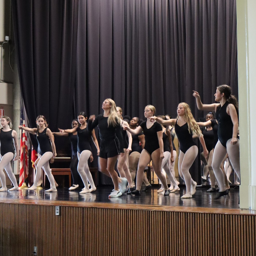 A group of students working on choreography with guest choreographer Ally Hopper.