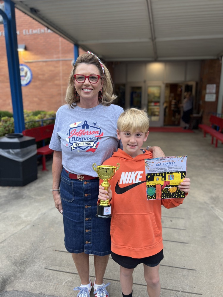 principal with art contest winner