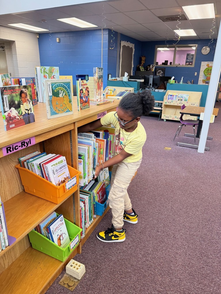 3rd Graders Shelving Books