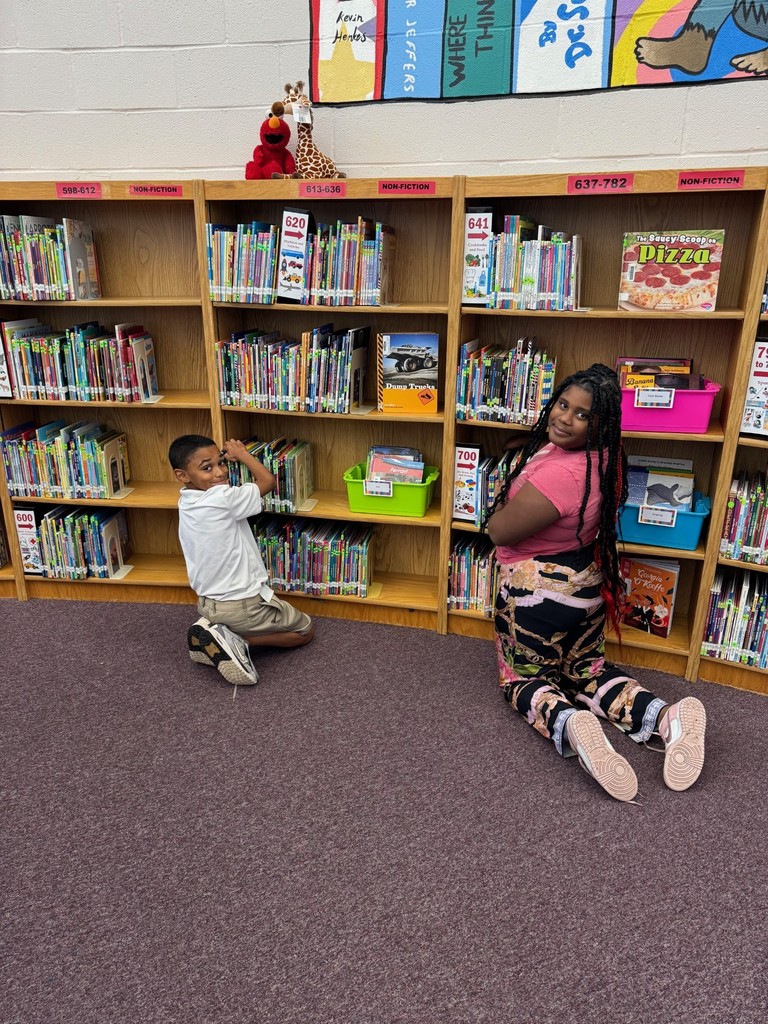 4th Graders Shelving Books