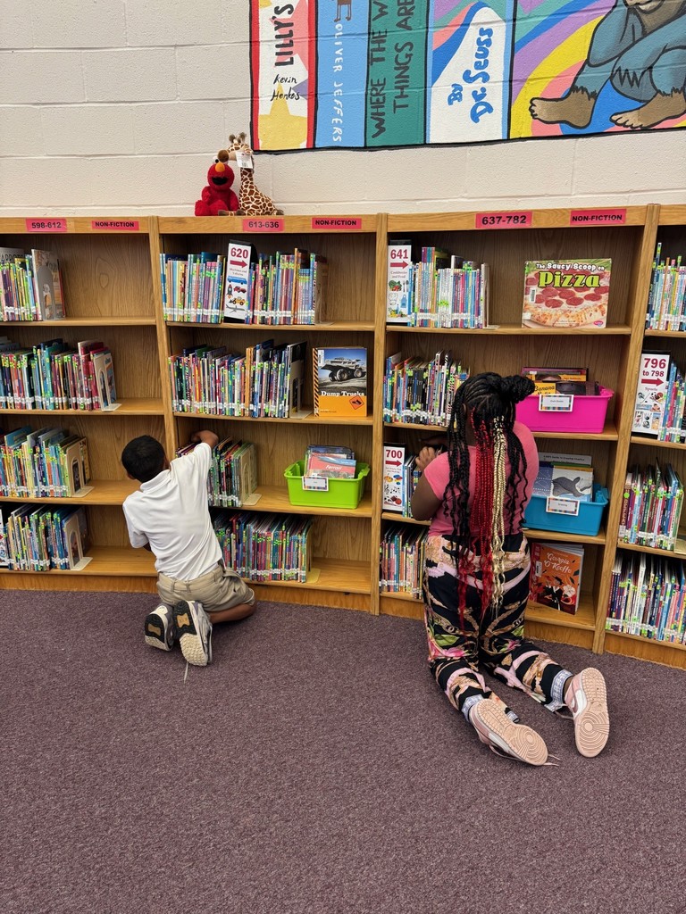 4th Graders Shelving Books