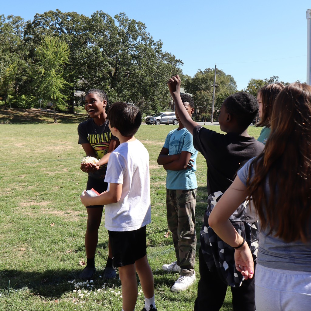 Students holding a handful of popcorn preparing for the activity.