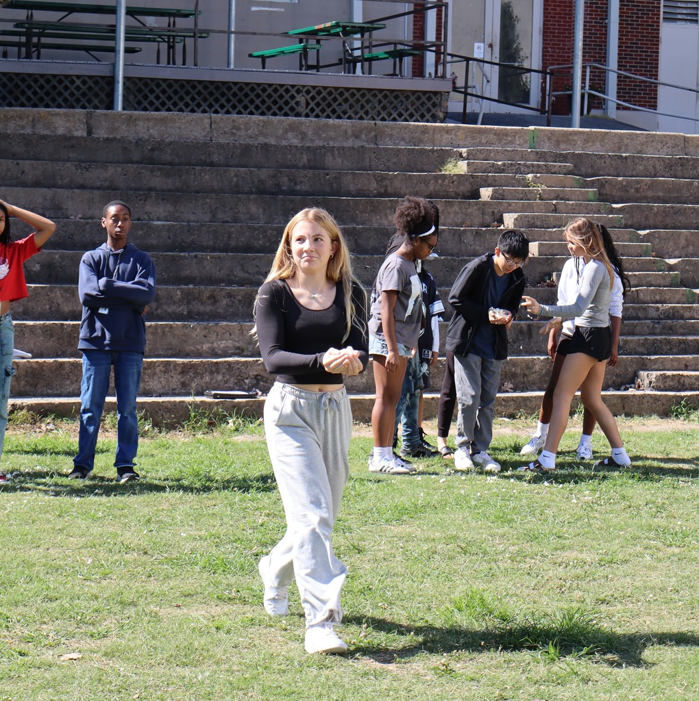 A student carrying popcorn in a science relay