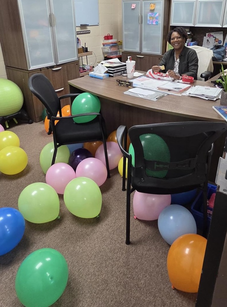 ms collins in her office with balloons