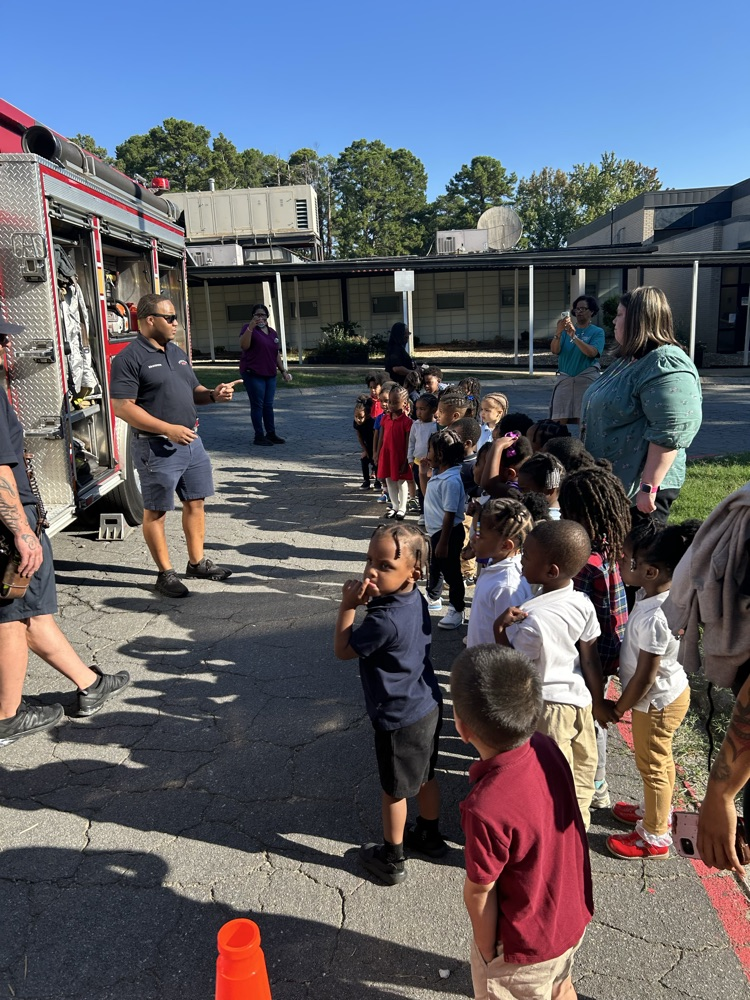 PreK3 Ms. Broadway & Ms. O’Gwin & Ms. Dreher & Ms. Conway’s PreK 3 students watch the firemen explain their community job.