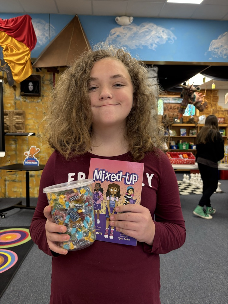 student with book and candy