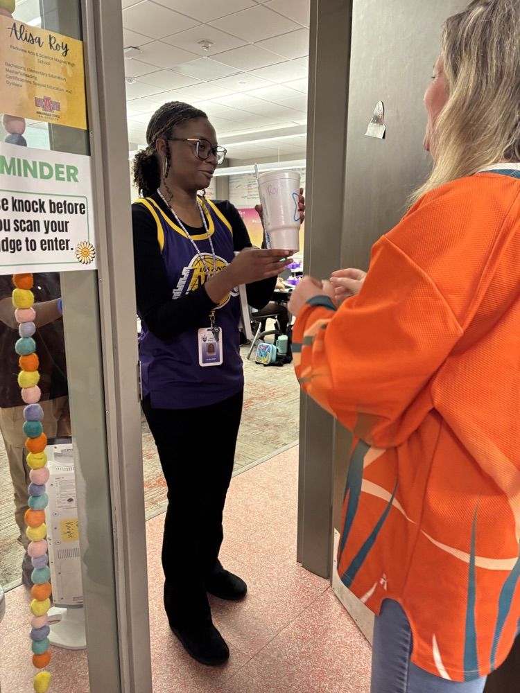 A teacher is being handed a sonic drink