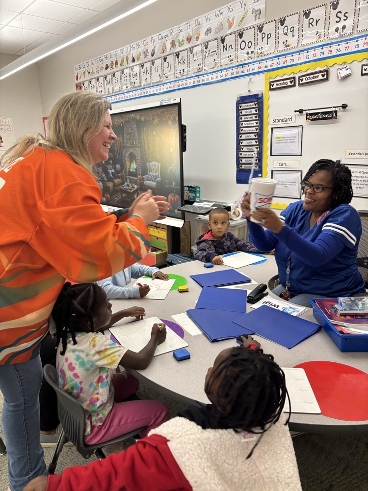 A teacher is being handed a sonic drink