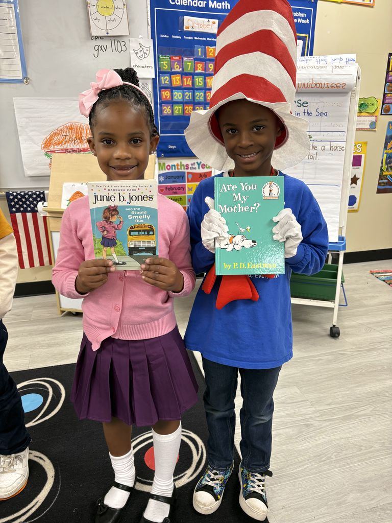Image of a student dressed like book character Junie B. Jones and another as Cat in the Hat.