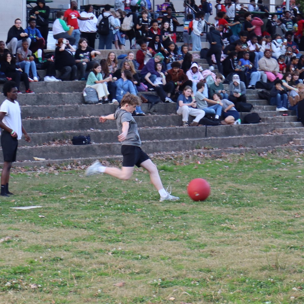 A student kicking the ball