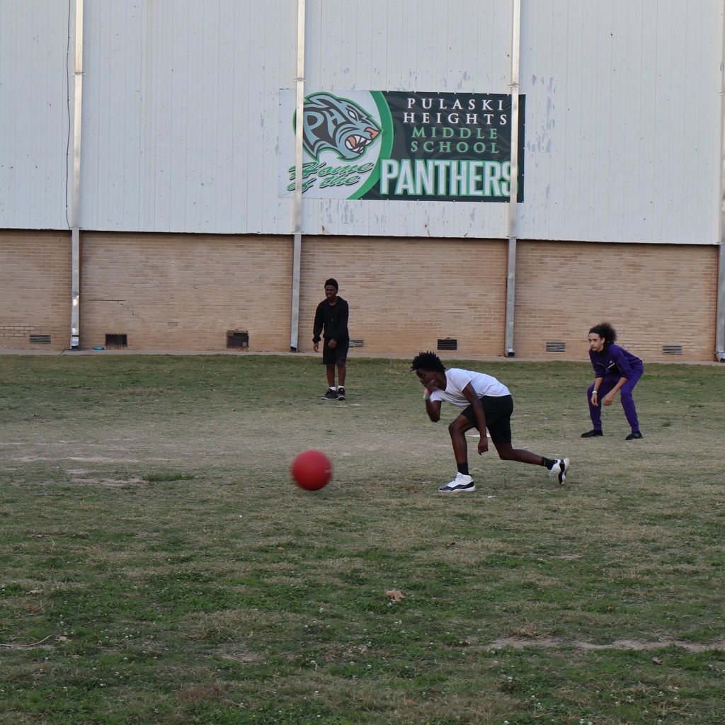 A student "pitching" the ball