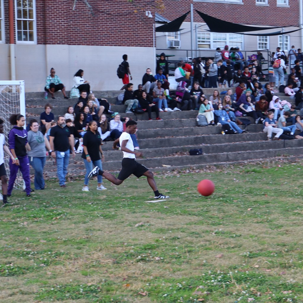 A student kicking the ball