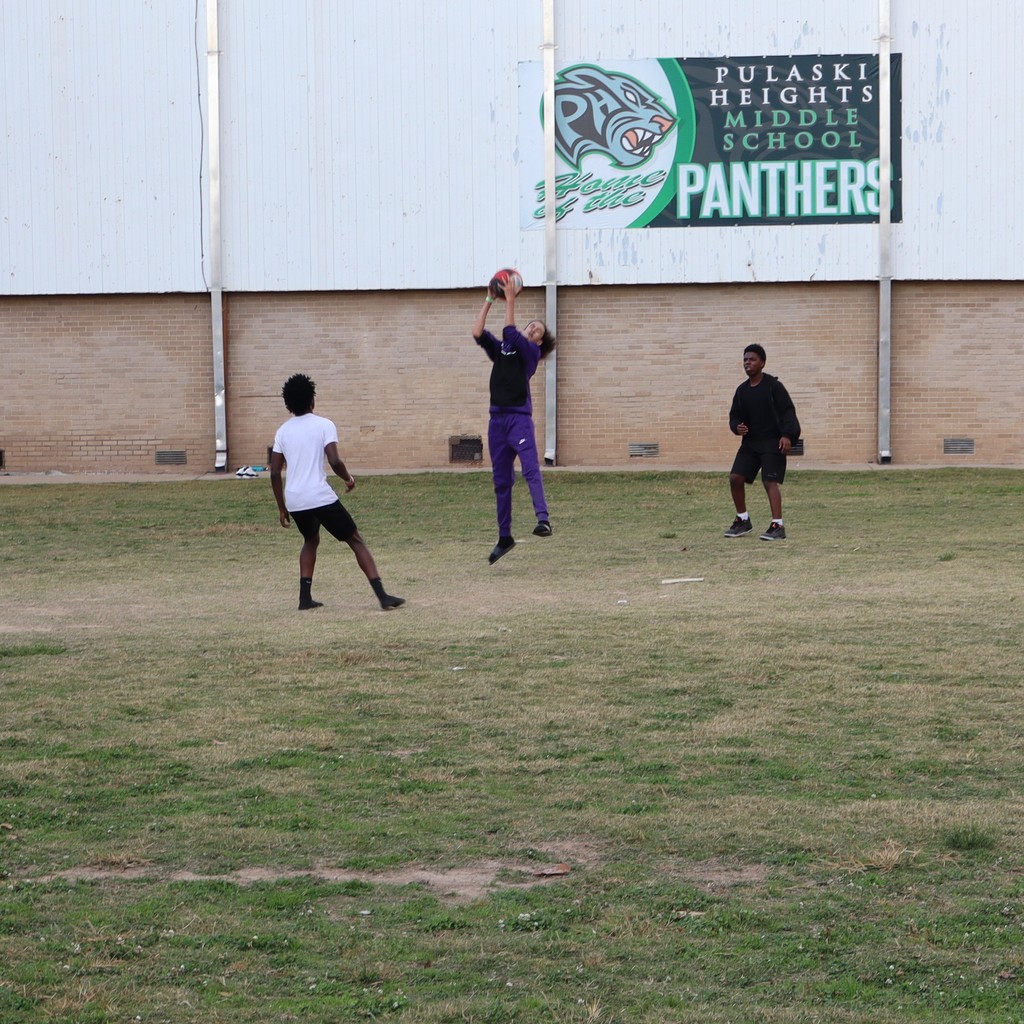 A student jumping to make an out