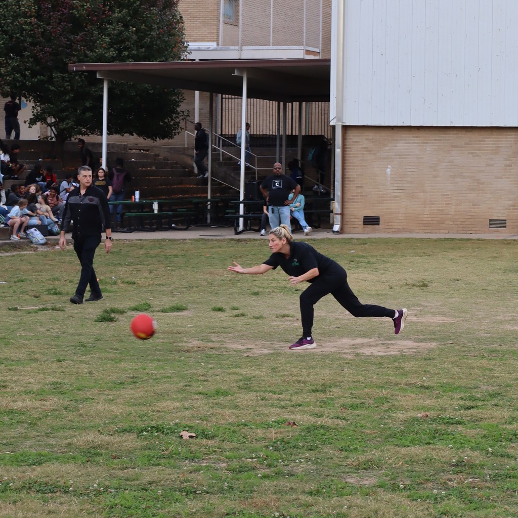 A teacher pitching the kickball